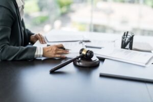 Attorney reviewing legal documents at a desk with a judge’s gavel and scales of justice symbolizing a motorcycle accident claim.